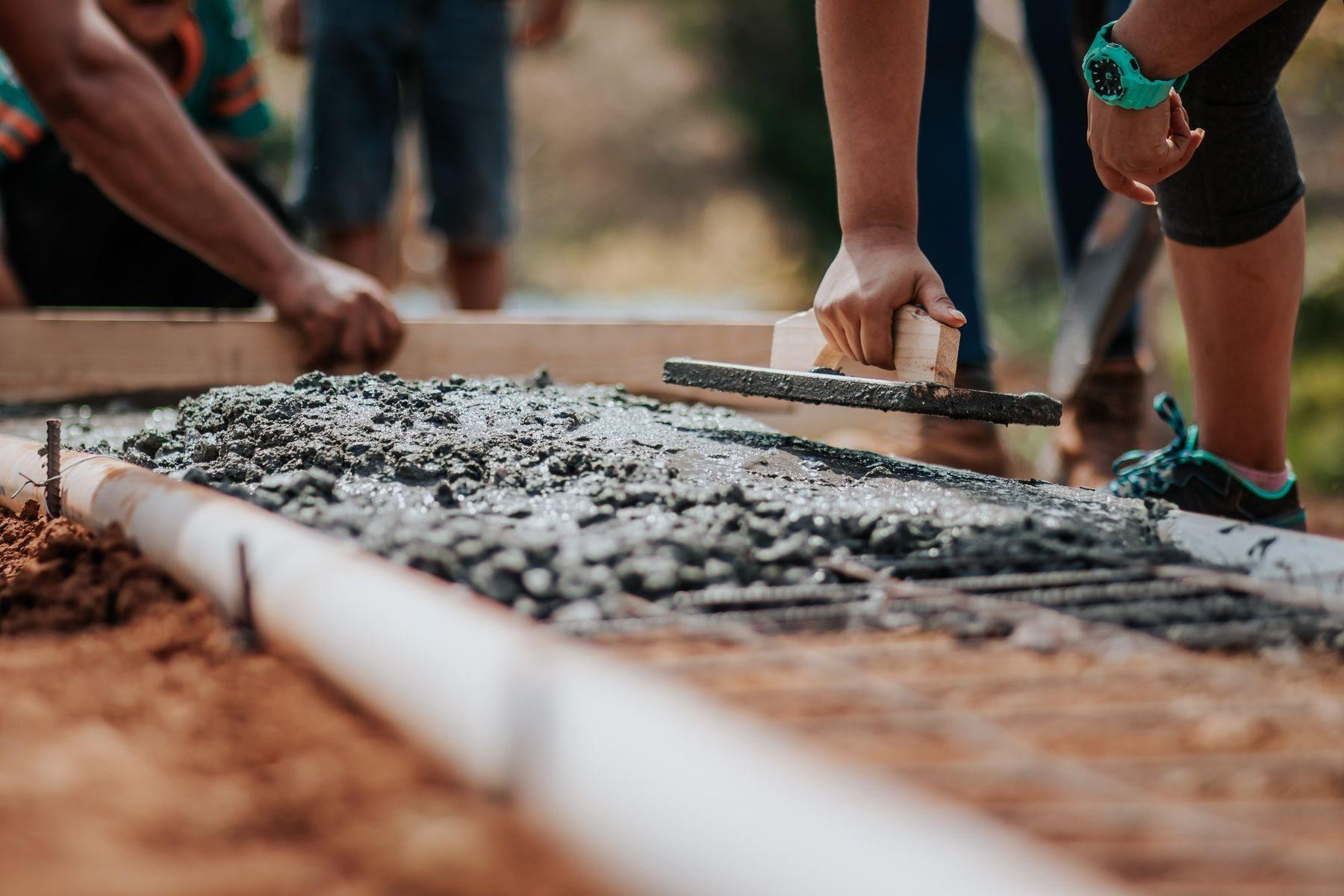 Fresh concrete being finished on a construction site